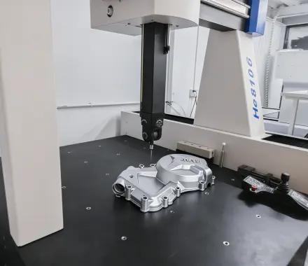 Coordinate measuring machine inspecting cast part