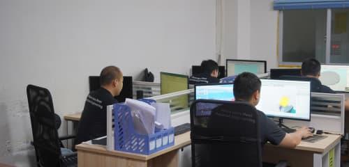 JS Precision engineering team collaborating in office