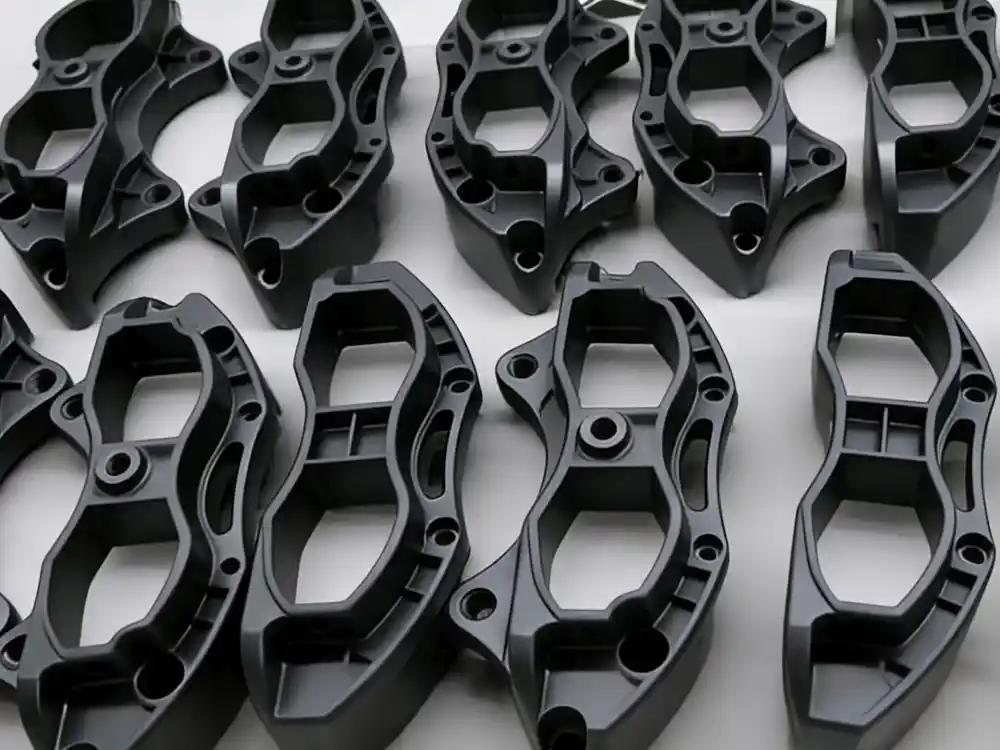 Vacuum cast automotive components arranged on white background