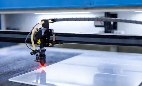 CO2 laser cutting head on sheet material