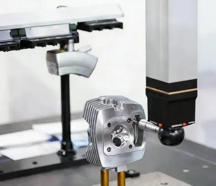 CMM probe measuring a complex machined aluminum part