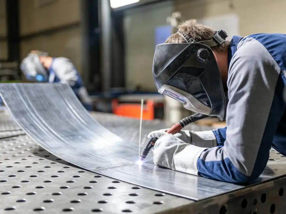 Interior view of the metal welding shop with workstations and fabrication equipment