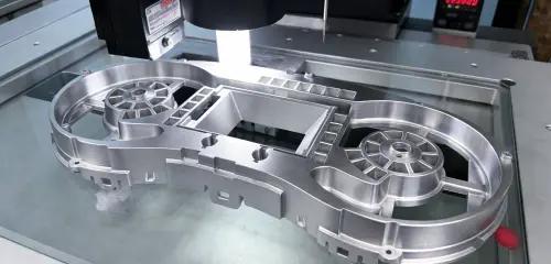 Finished metal welded component on a bright inspection table