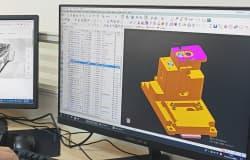 Design for manufacturing engineers reviewing consumer product parts