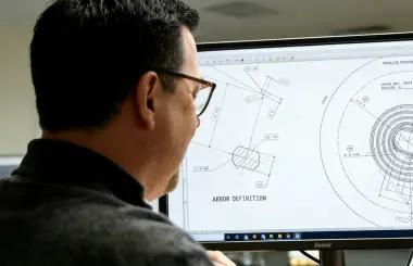 Engineer reviewing custom spring drawing