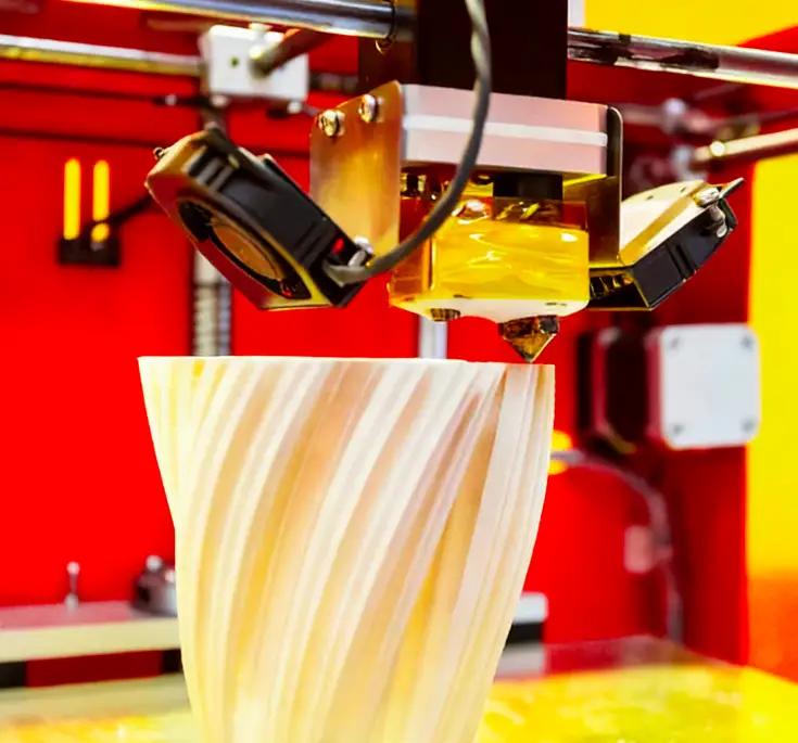 3D printer fabricating a layered part on the build plate